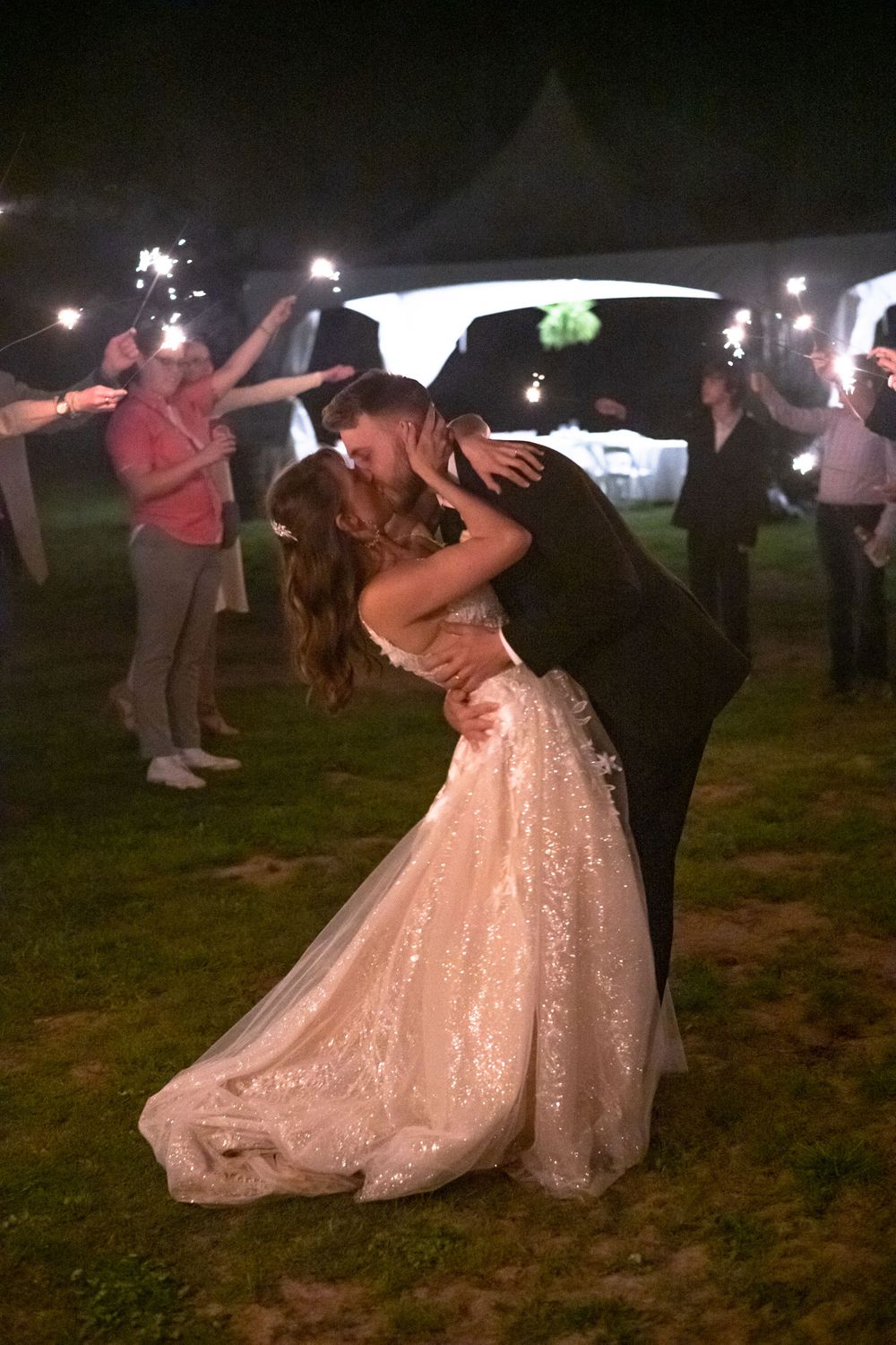 A romantic dip dance at night with sparklers glowing in the background.