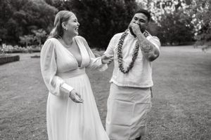 Black and white photo of wedding couple sharing an emotional moment outdoors.