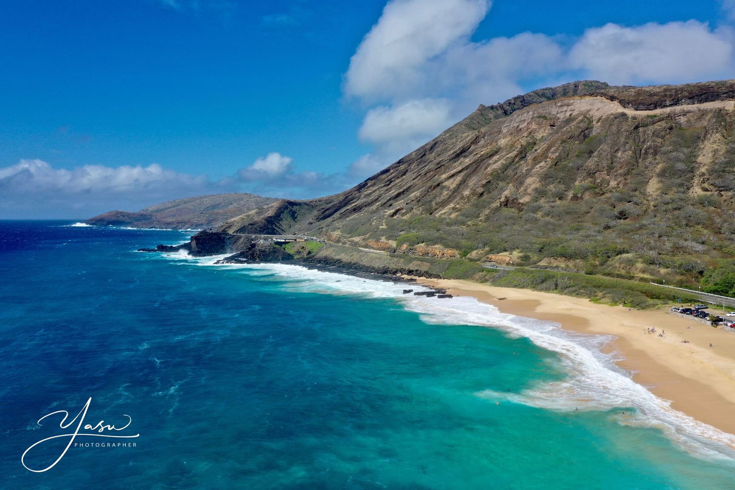 Aerial view of a stunning Hawaiian beach with turquoise waters, white sand, and dramatic green cliffs under a blue sky.
ハワイウェディング
ハワイ挙式