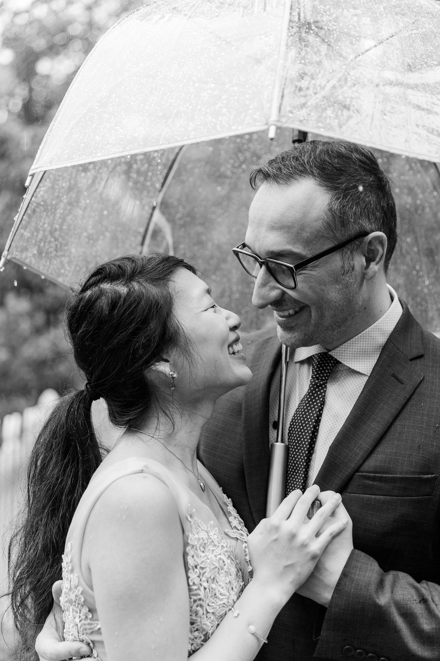 Black and white romantic portraits under a white umbrella.