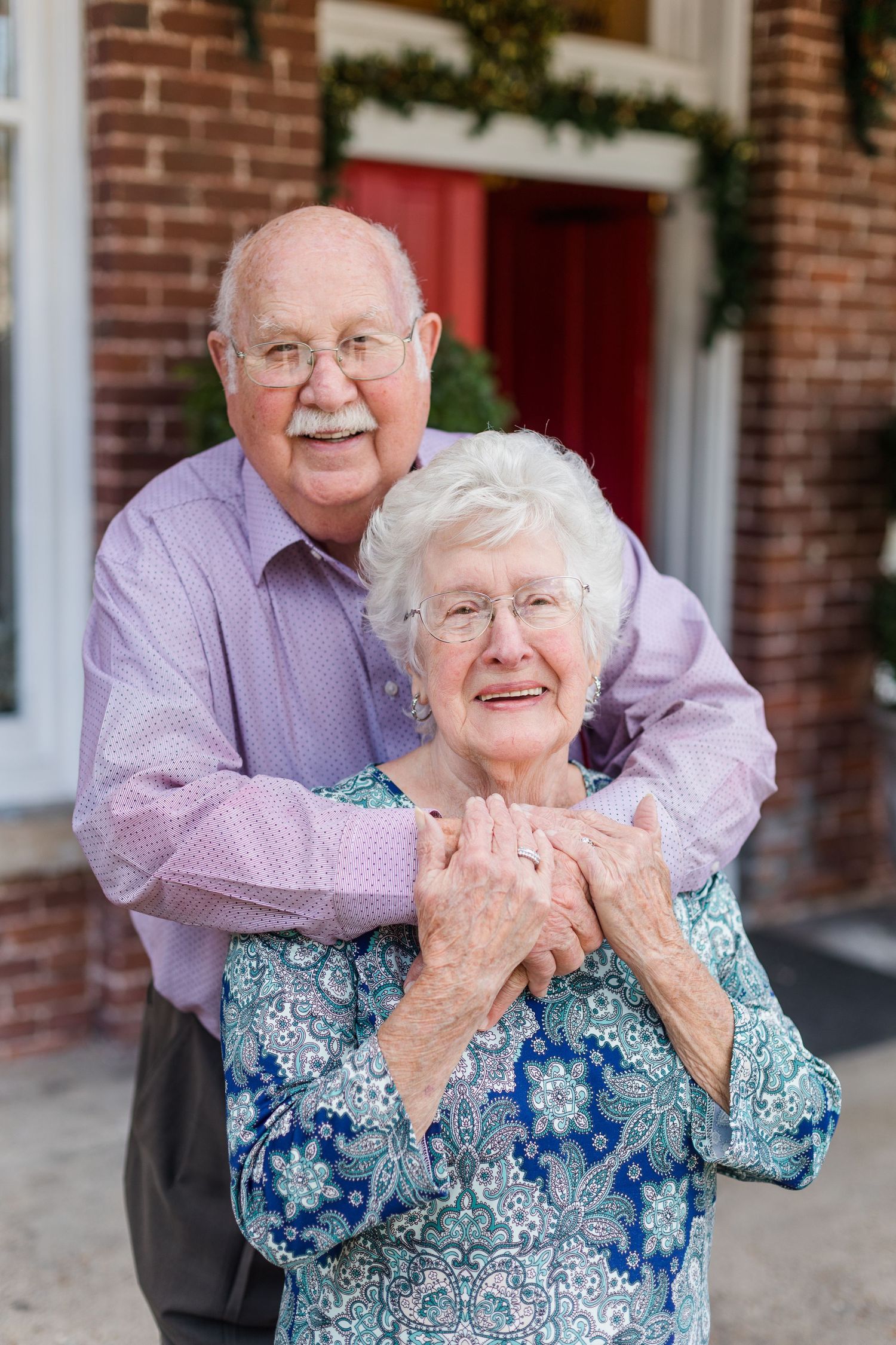 Elderly couple sharing joyful moment together outdoors.