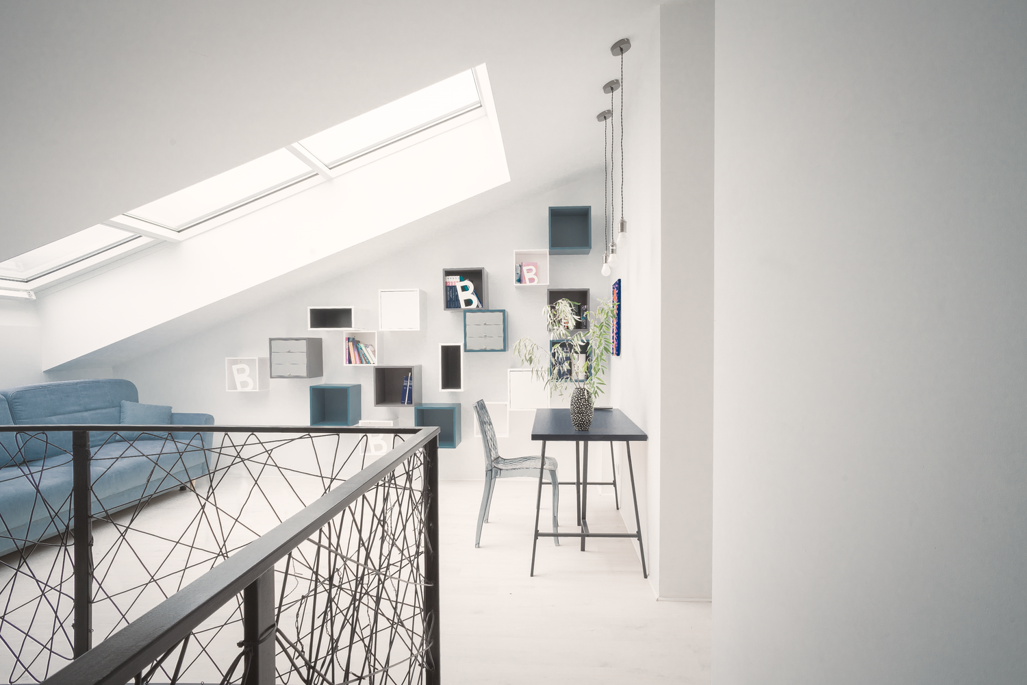 Modern white loft space with geometric railing and skylight.