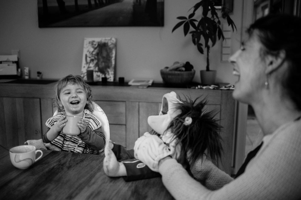 Black and white indoor scene showing intimate moments of daily life.