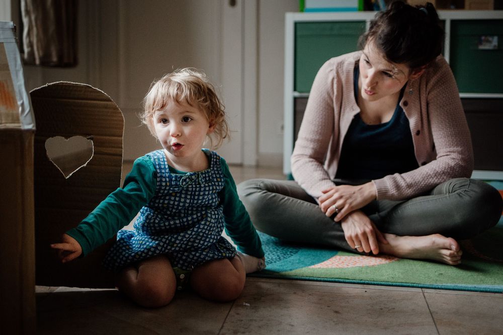 A cozy indoor scene with wooden floors and natural lighting through windows.