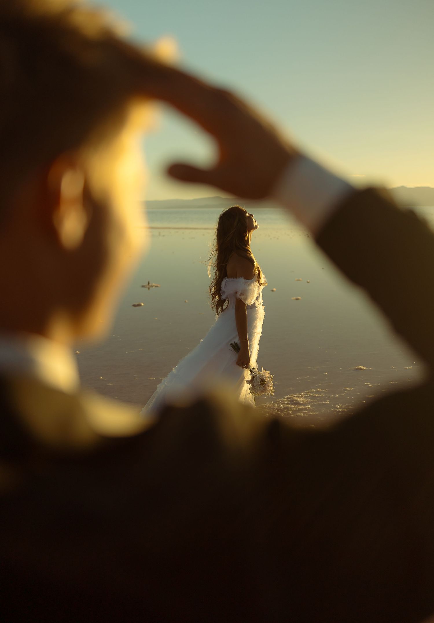 Bride cinematically soaking in the sun through husband's arm
