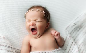 A newborn girl yawning in her image. - Greenville SC newborn photographer - Easley SC newborn photographer
