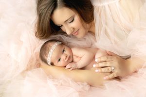 Mom lying next to newborn baby girl. - Greenville SC newborn photographer - Easley SC newborn photographer