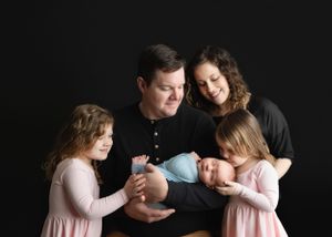 Mom, Dad, and sisters holding their newborn, showing their connection. - Greenville SC newborn photographer - Easley SC newborn photographer