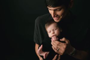 Showing a dad's connection holding a newborn boy. - Greenville SC newborn photographer - Easley SC newborn photographer