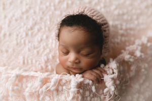 Black newborn girl in a light pink blanket and hat. - Greenville SC newborn photographer - Easley SC newborn photographer
