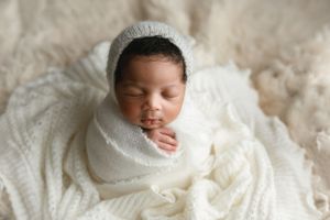 An black newborn baby girl in cream on cream blankets. - Greenville SC newborn photographer - Easley SC newborn photographer