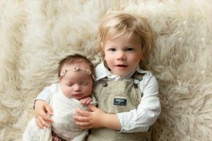 Little blonde boy holding his newborn sister so tenderly. - Greenville SC newborn photographer - Easley SC newborn photographer