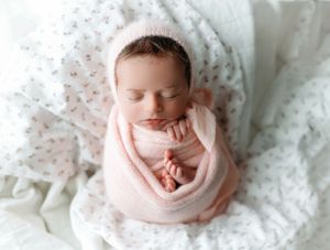 newborn girl on a floral layer wrapped in light pink. - Greenville SC newborn photographer - Easley SC newborn photographer
