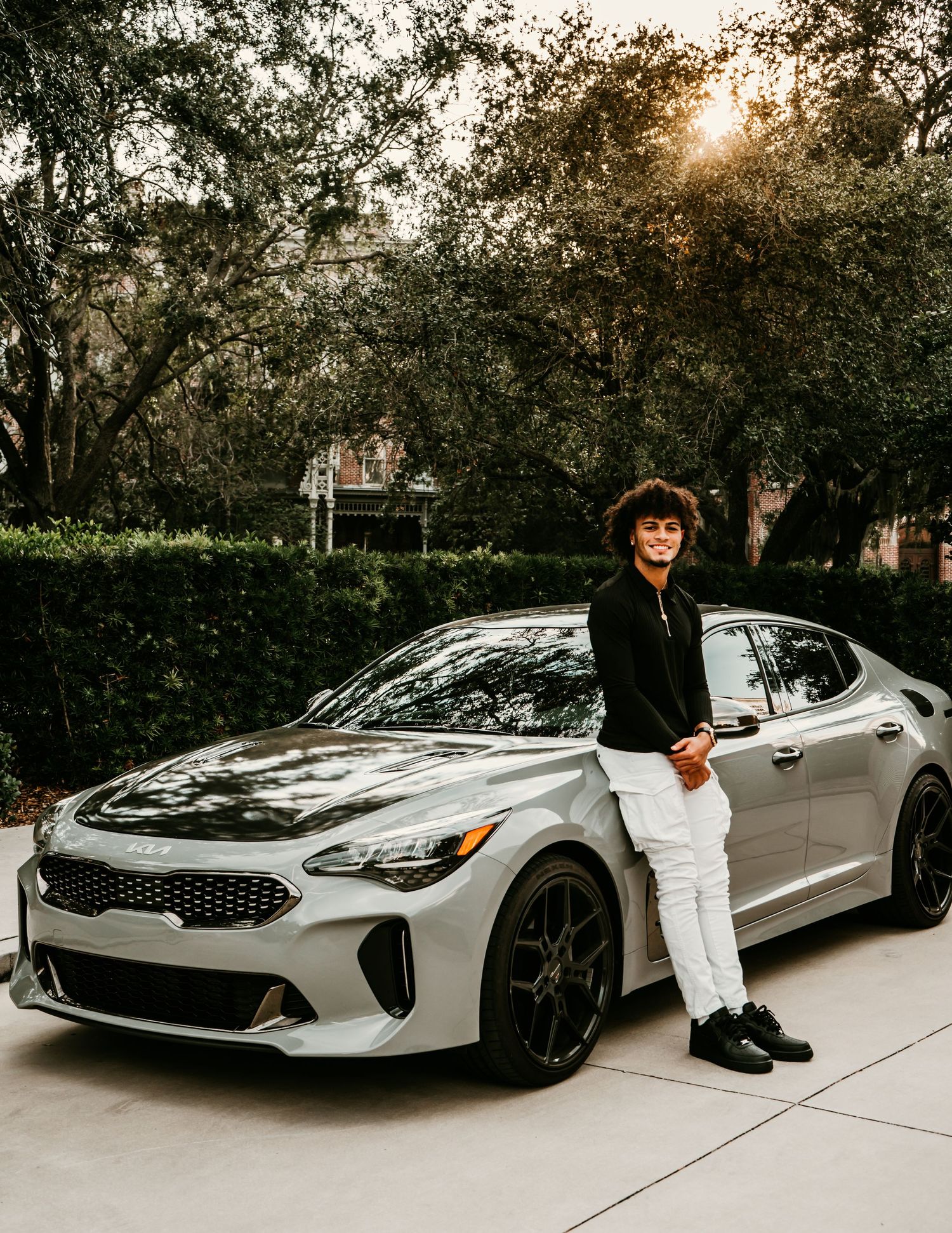 Outdoor Senior Portrait Session at University of Tampa in Tampa, FL; Senior pictures, teen leaned against side of car