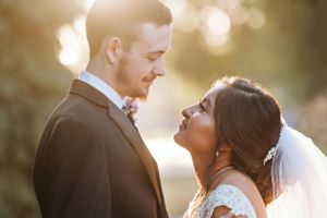 Bride and groom gaze at each other at sunset