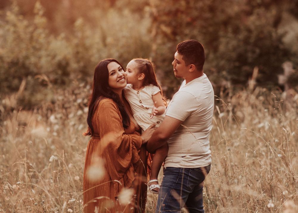 Series of natural family moments photographed in a rustic field setting with warm autumn tones.