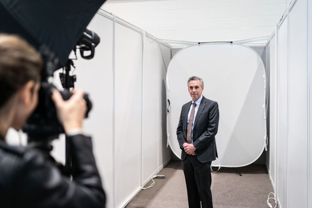 Delegates pose for complimentary headshots during the CFA Global Conference at ExCel London