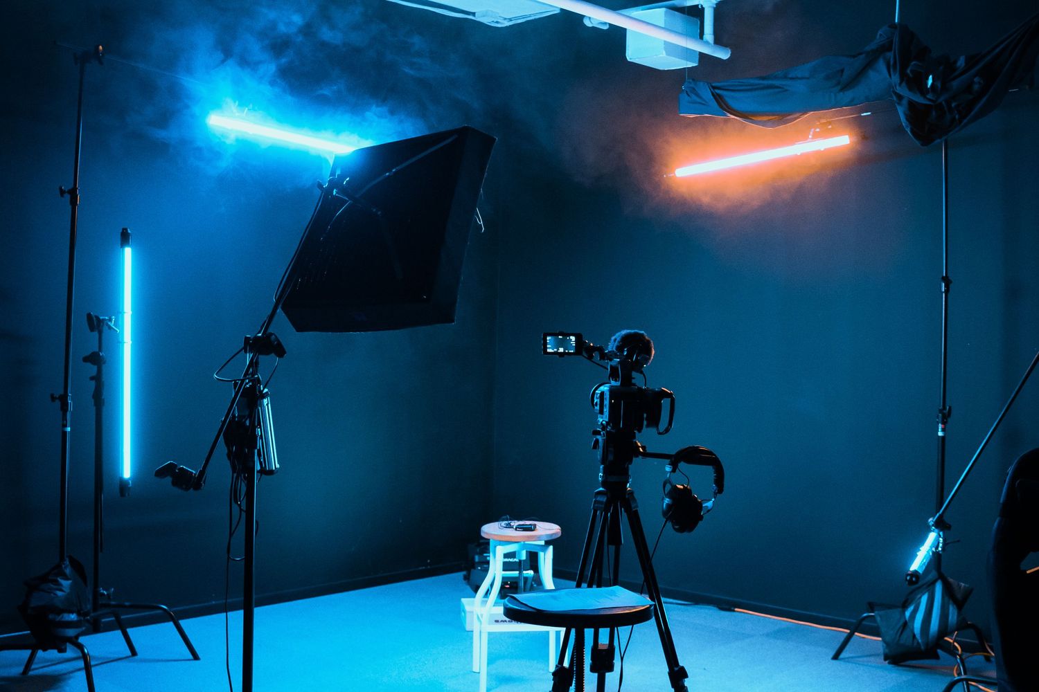 Professional photography studio setup with dramatic blue and orange lighting effects.