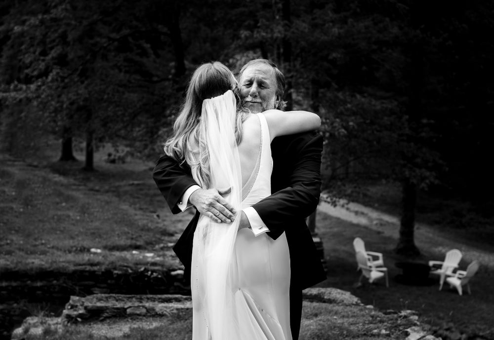A joyful wedding celebration captured in black and white photography.