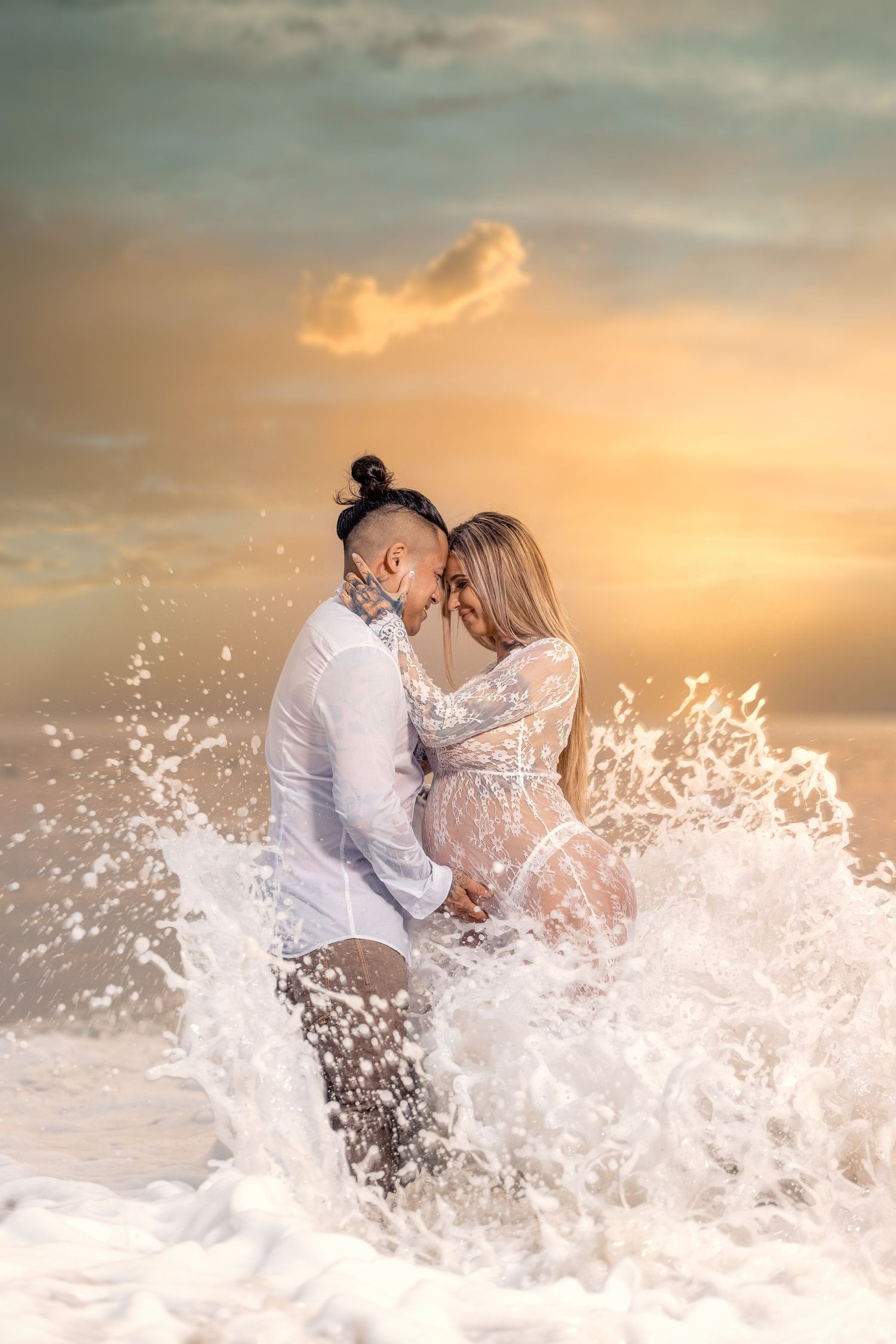 Couple embracing in ocean waves during golden sunset with dramatic water splash.