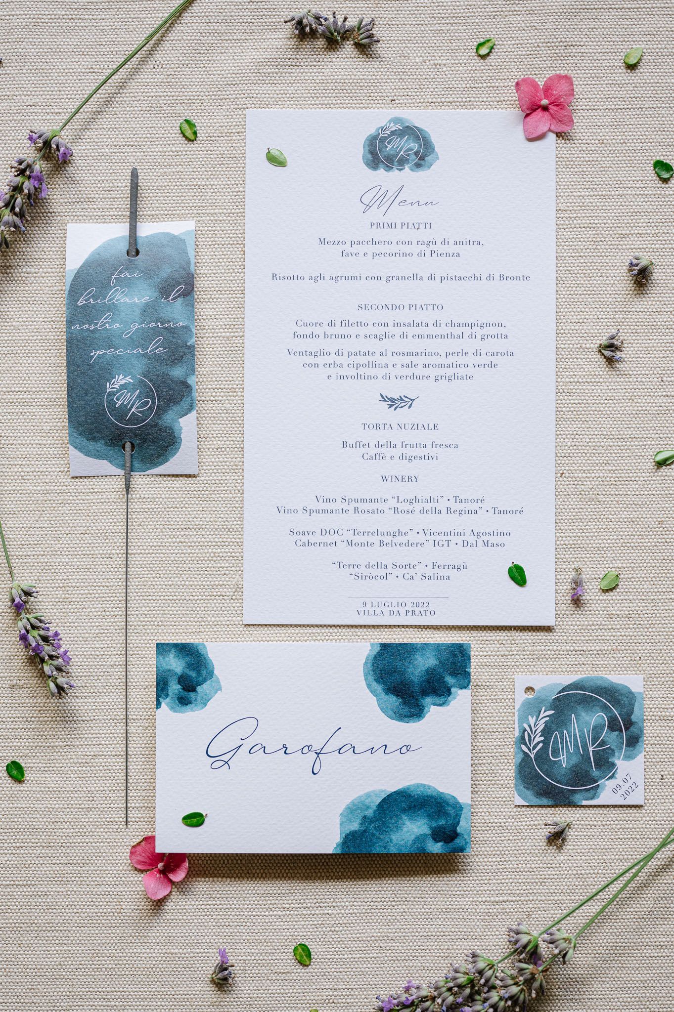 Wedding stationery suite featuring watercolor blue designs and floral elements with menu details.