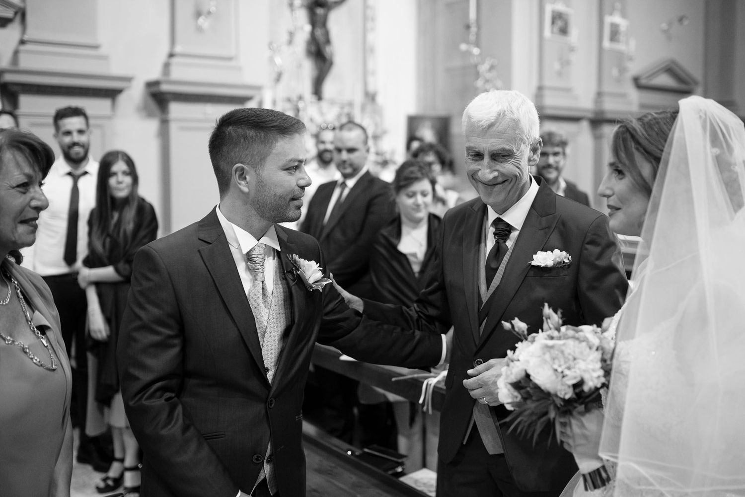 Black and white photo of a wedding ceremony inside a traditional church.