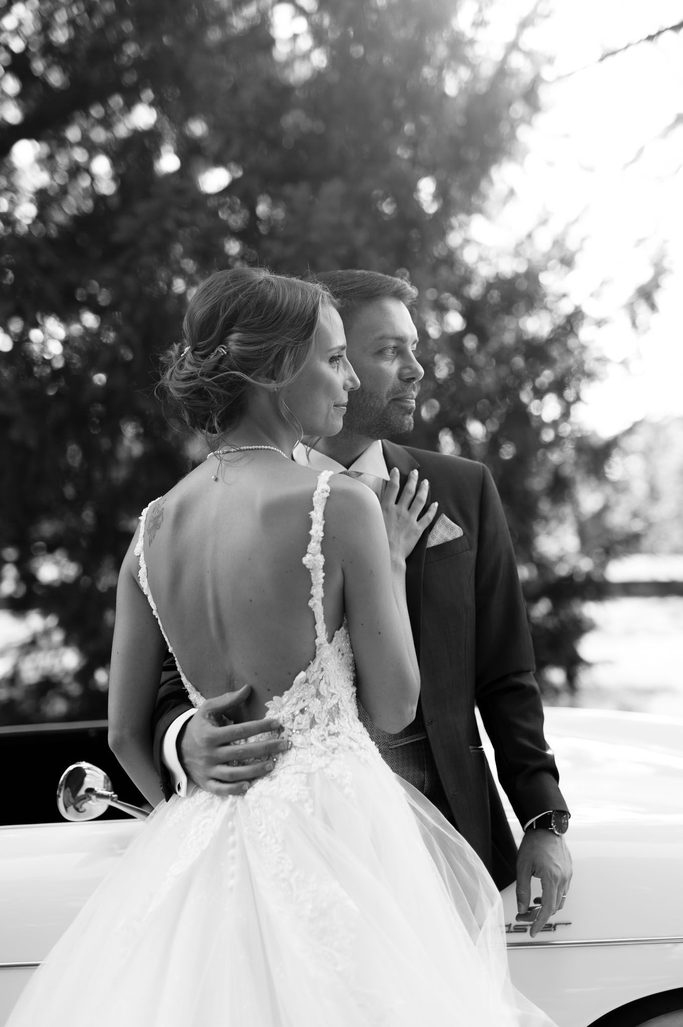 Romantic black and white portrait showcasing bride's detailed lace back wedding dress.