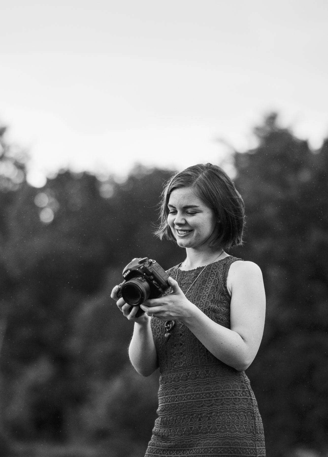 Photo of woman with short hair holding camera