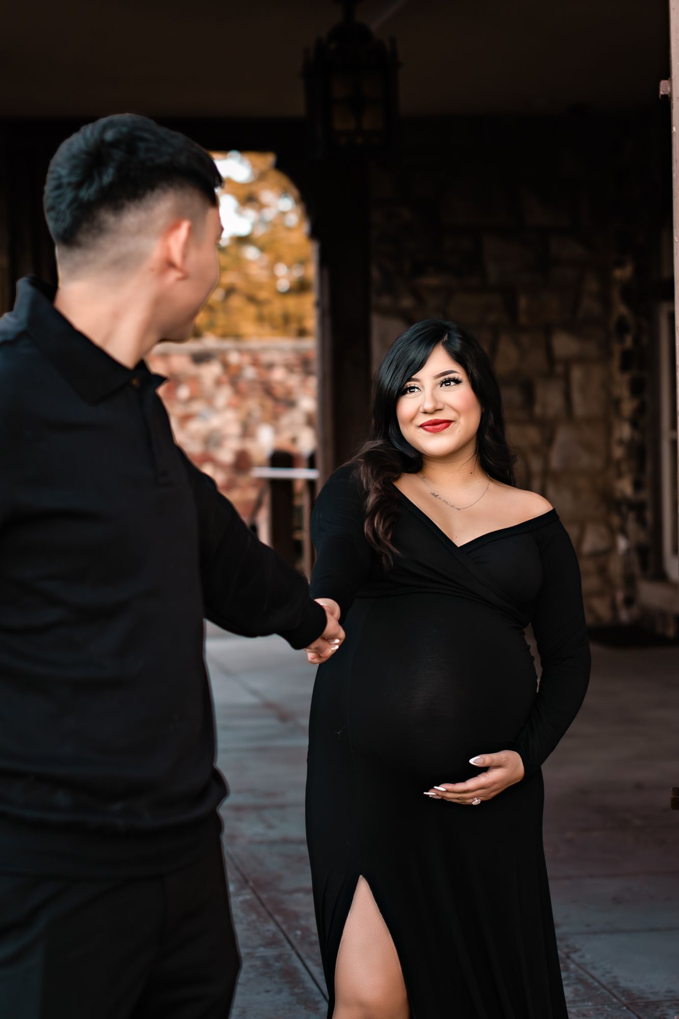 pregnant woman smiling at her husband while he leads her
