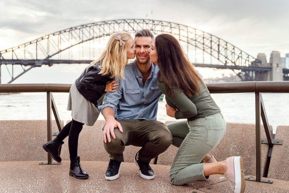 Mother and daughter giving kiss during a family photoshoot in Sydney
