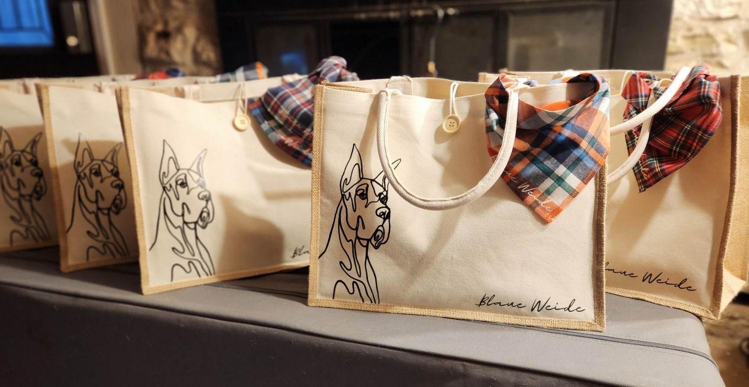 Custom Great Dane tote bags with plaid bow ties displayed on a mantel.