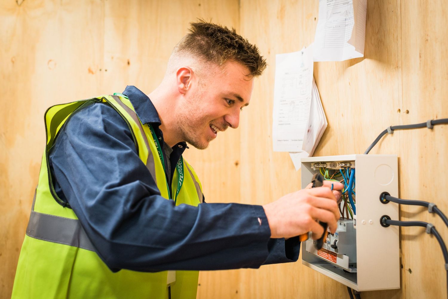 Apprentice electrician working on practice wiring