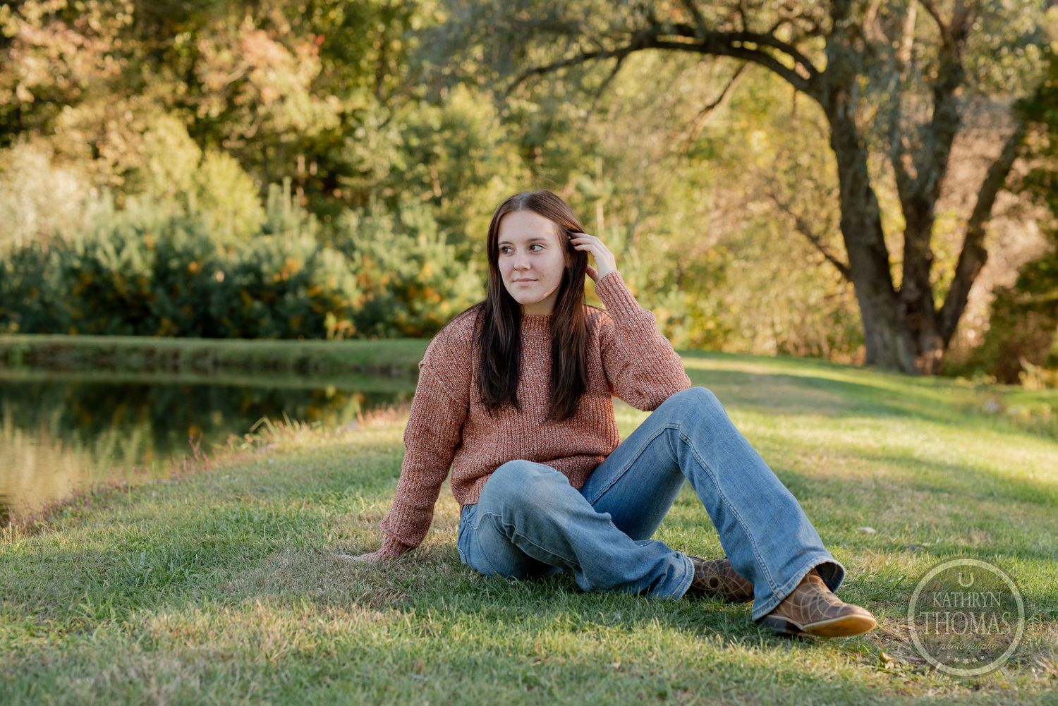 Autumn outdoor portrait showcasing casual style against golden evening light and trees.