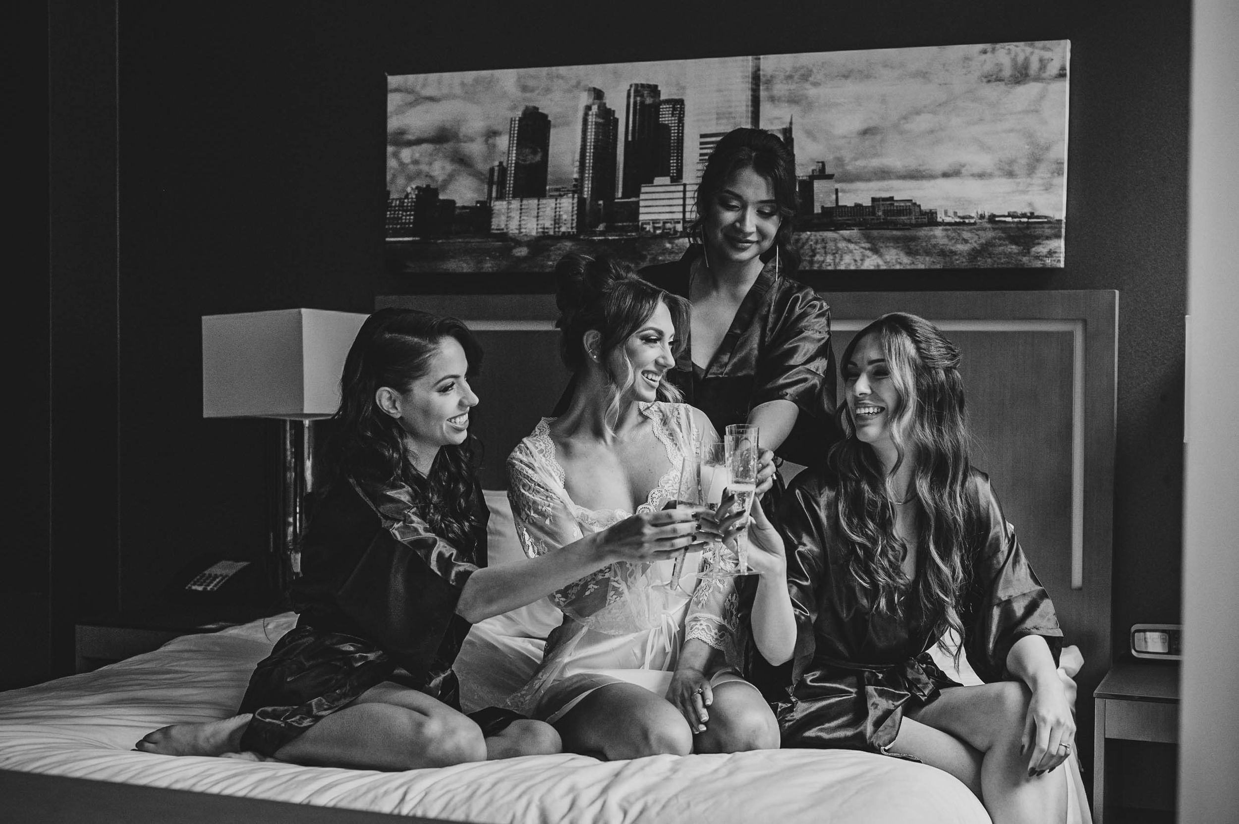 Black and white candid getting ready moments in a hotel room.