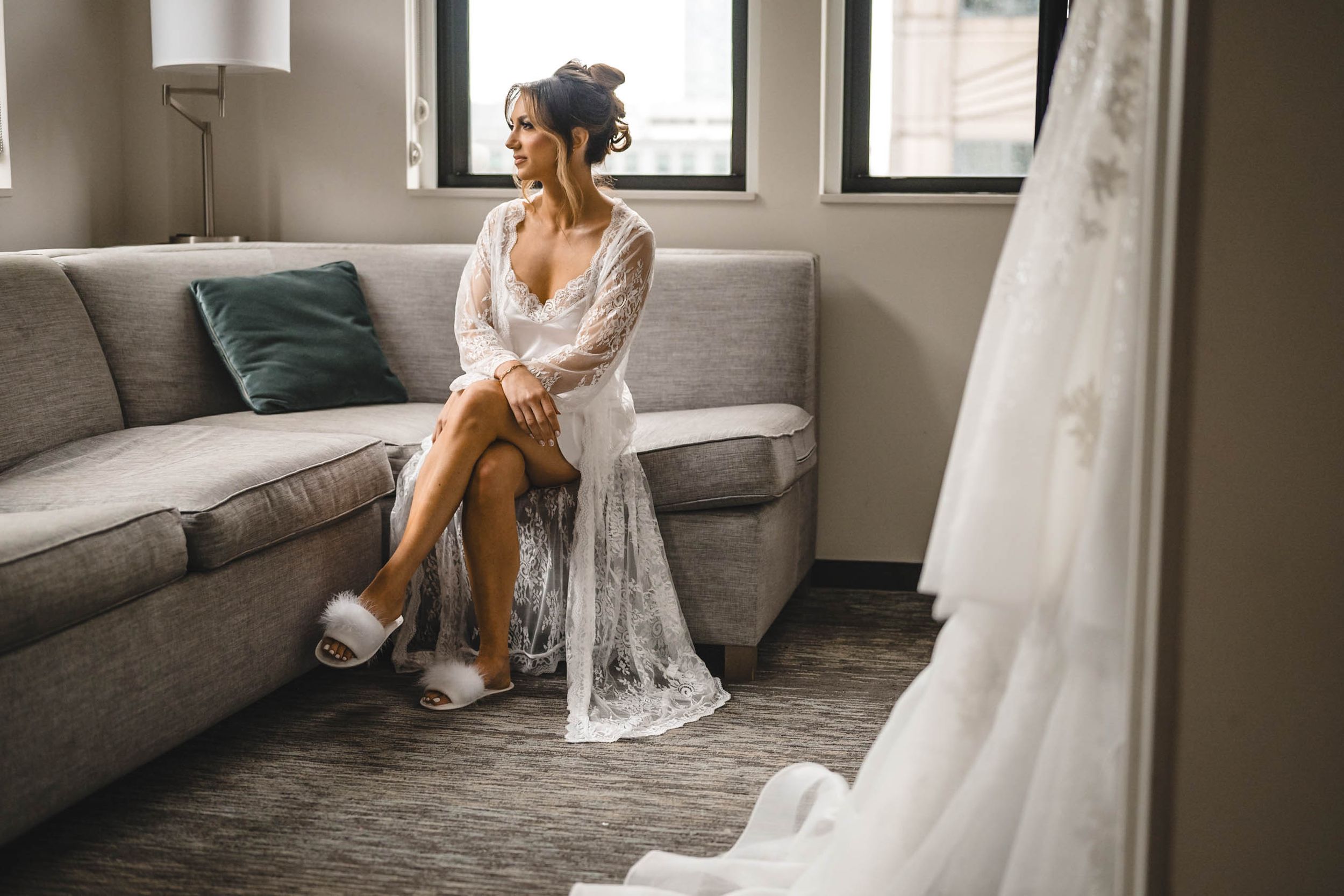 Wedding preparation scene in a modern room with grey furniture.
