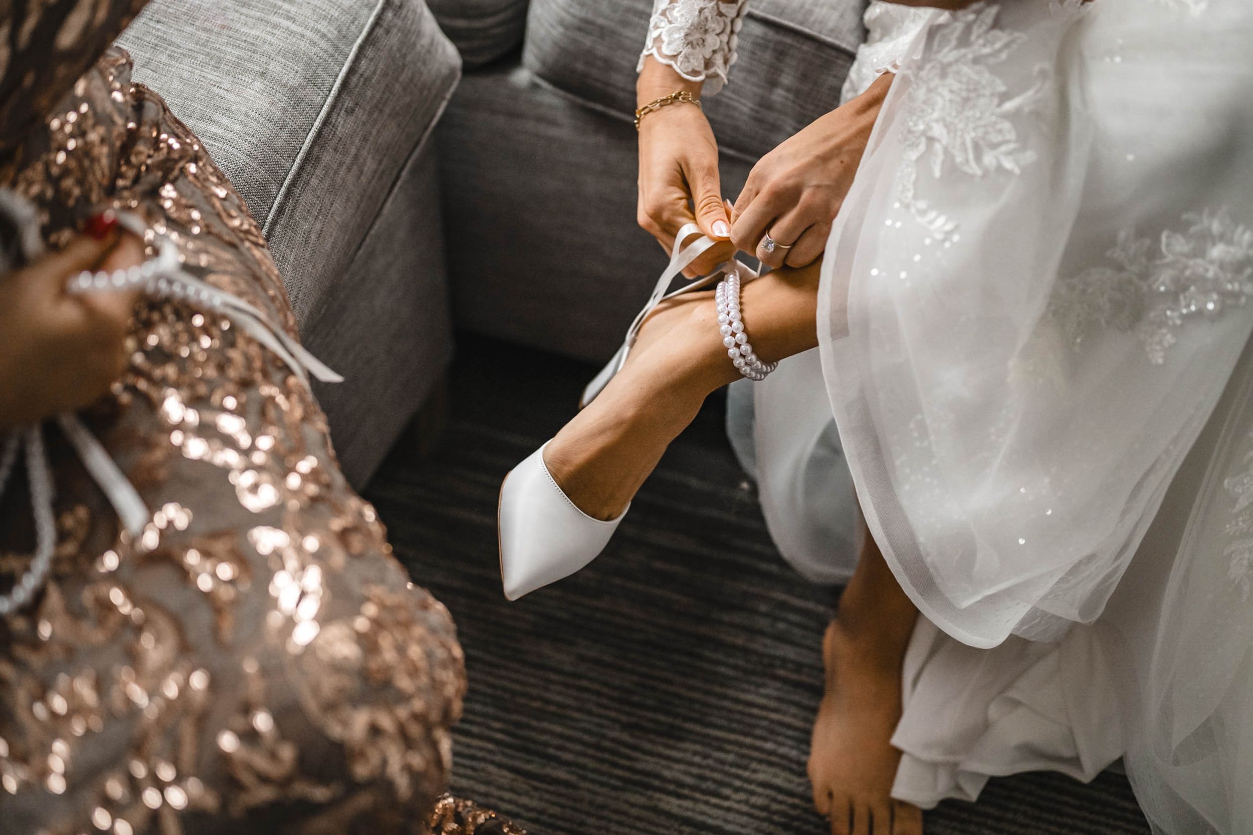 Detail shot of formal dresses and wedding gown textures in modern setting.