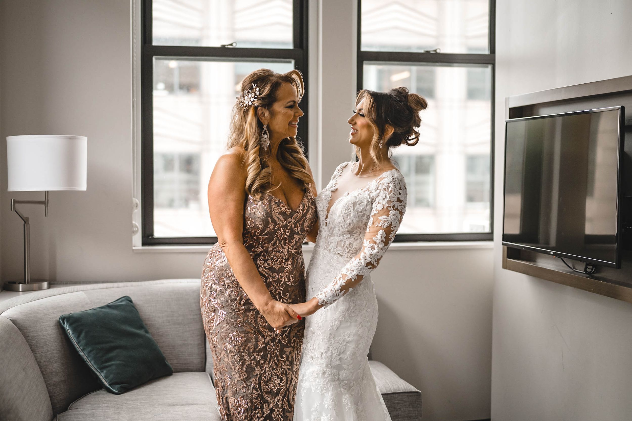 Modern apartment setting with black-framed windows during wedding preparation.