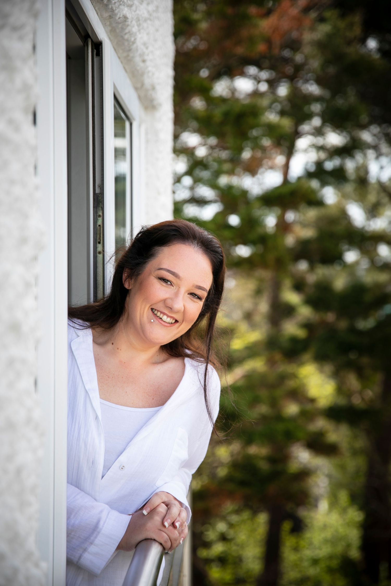Portrait sequence showing joyful expressions in white attire against an outdoor backdrop.