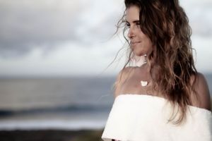 Bride in sunset natural pose by the ocean, wedding photography wedding poses Dorset