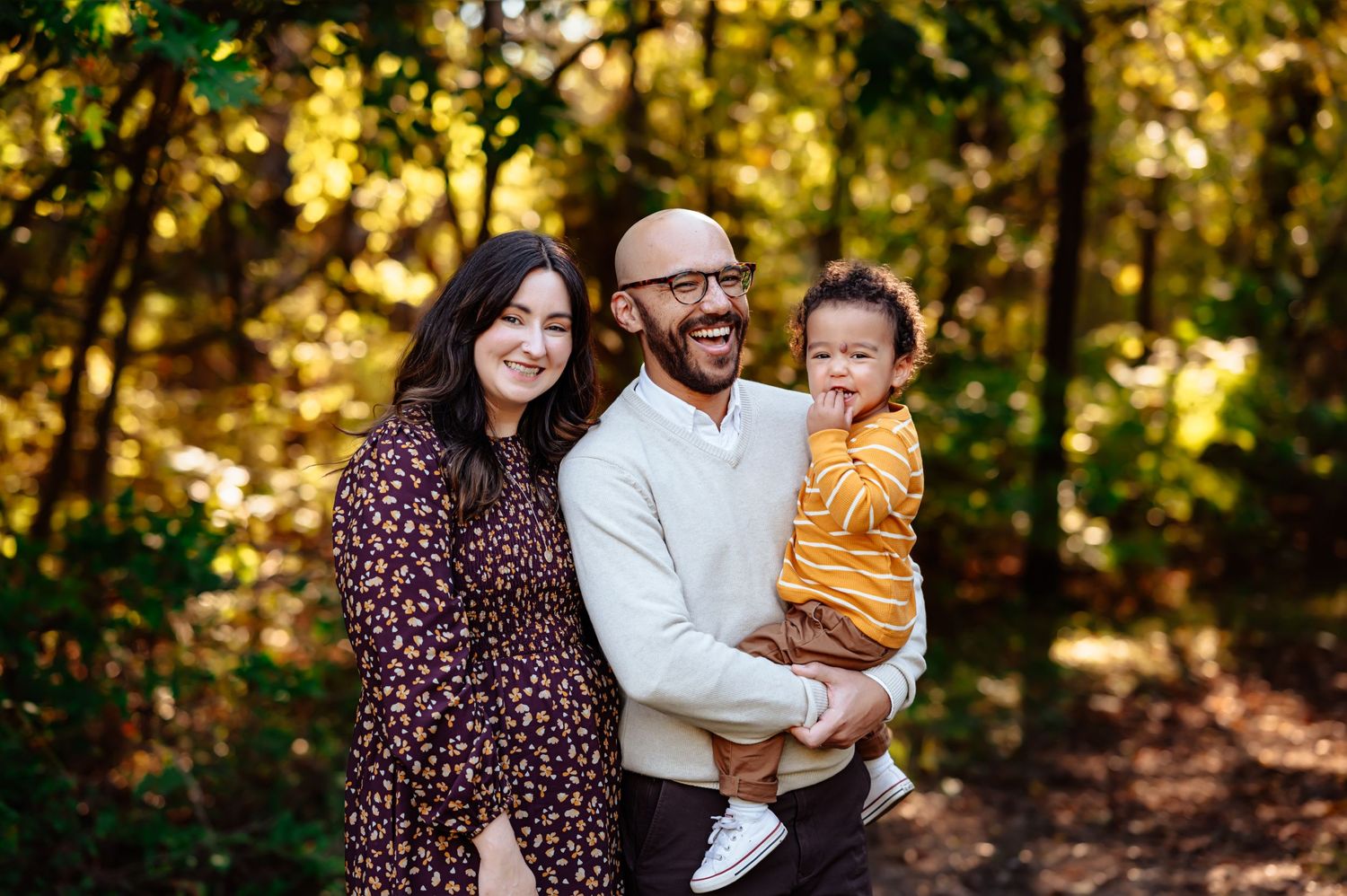 Dallas area family photo session, toddler with biracial mom and dad in outdoor DFW fall family photoshoot at sunset