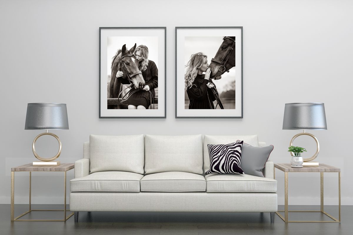 Modern living room interior with black and white equestrian photography prints and grey sofa.