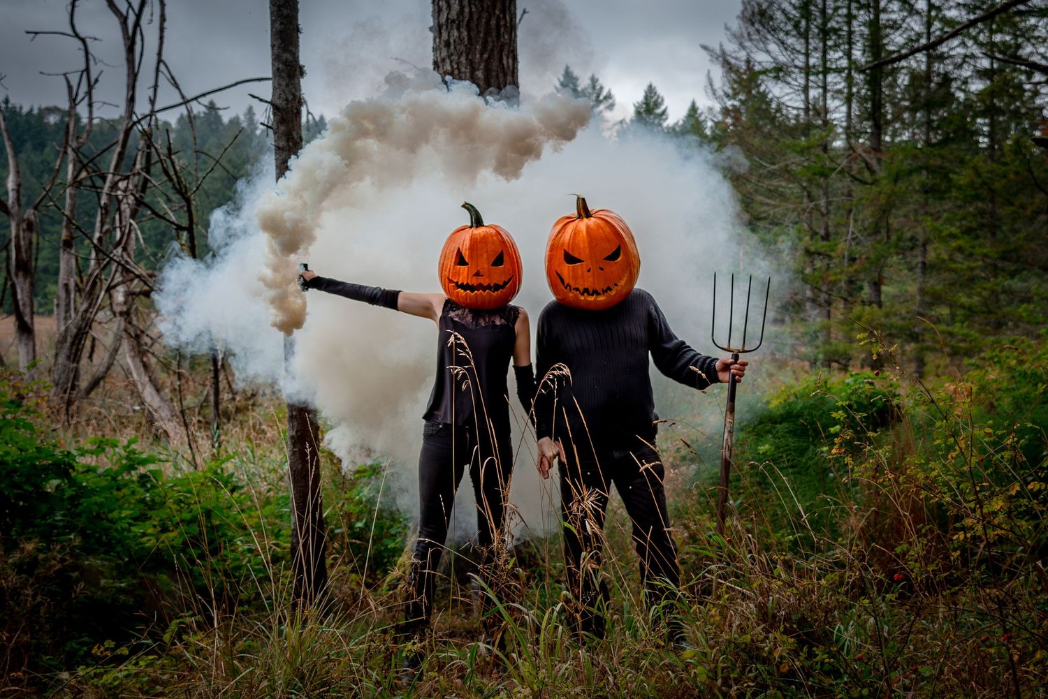 Salt Spring Island pumpkin people with jack-o-lantern heads in the spooky forest