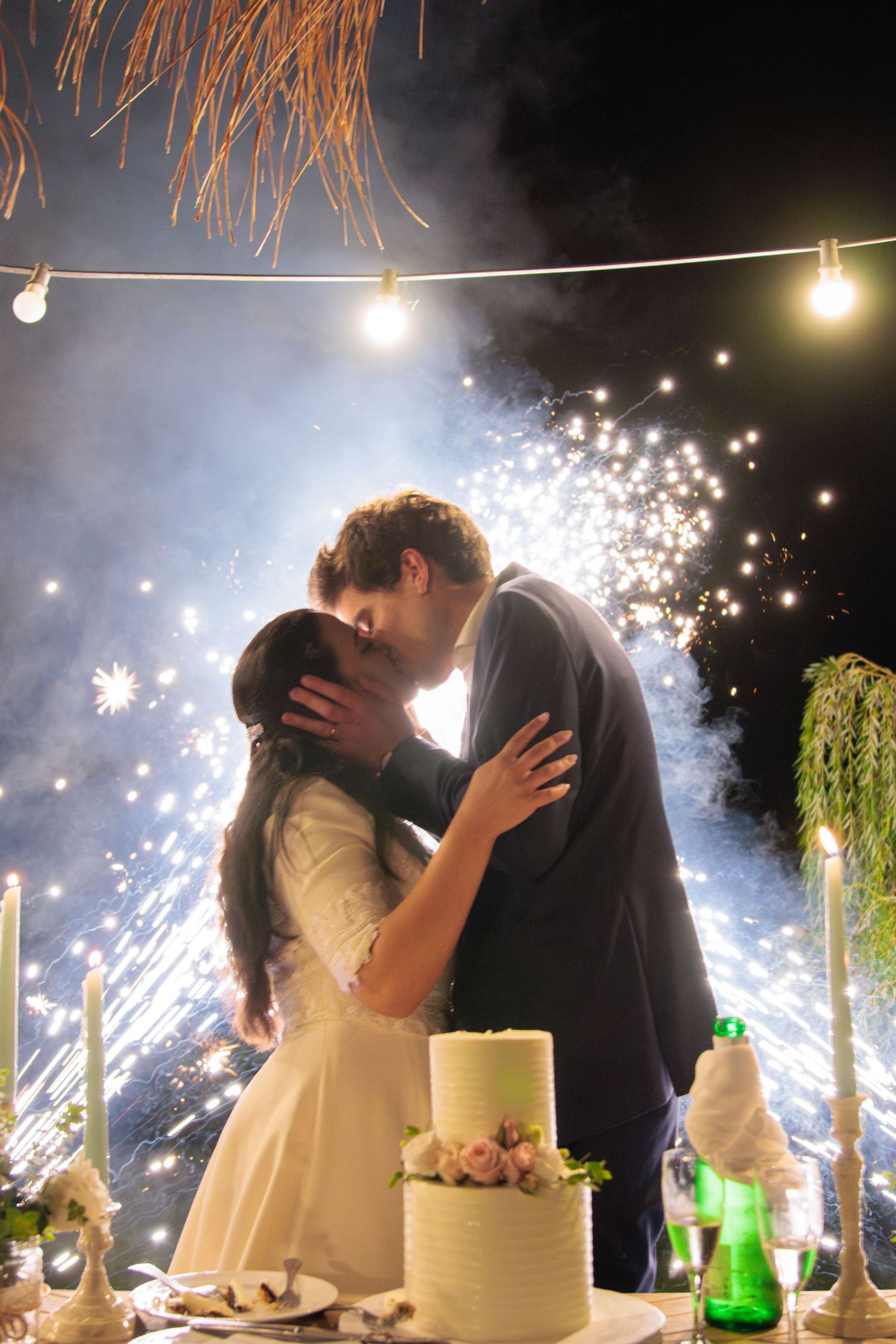 Wedding celebration with sparklers creating magical light effects during evening reception.