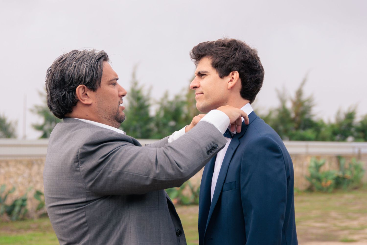 Sequence of emotional moments between people at outdoor wedding venue.