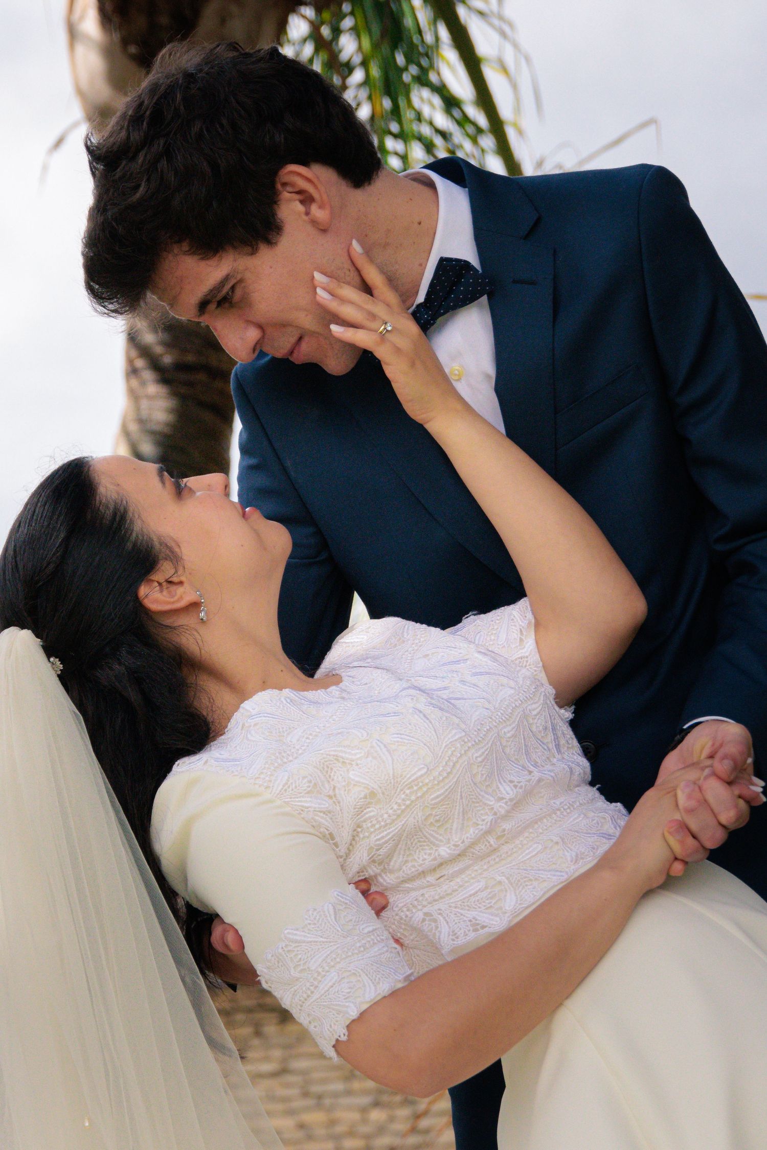 Close-up sequence of a tender moment between newlyweds during their wedding photoshoot.