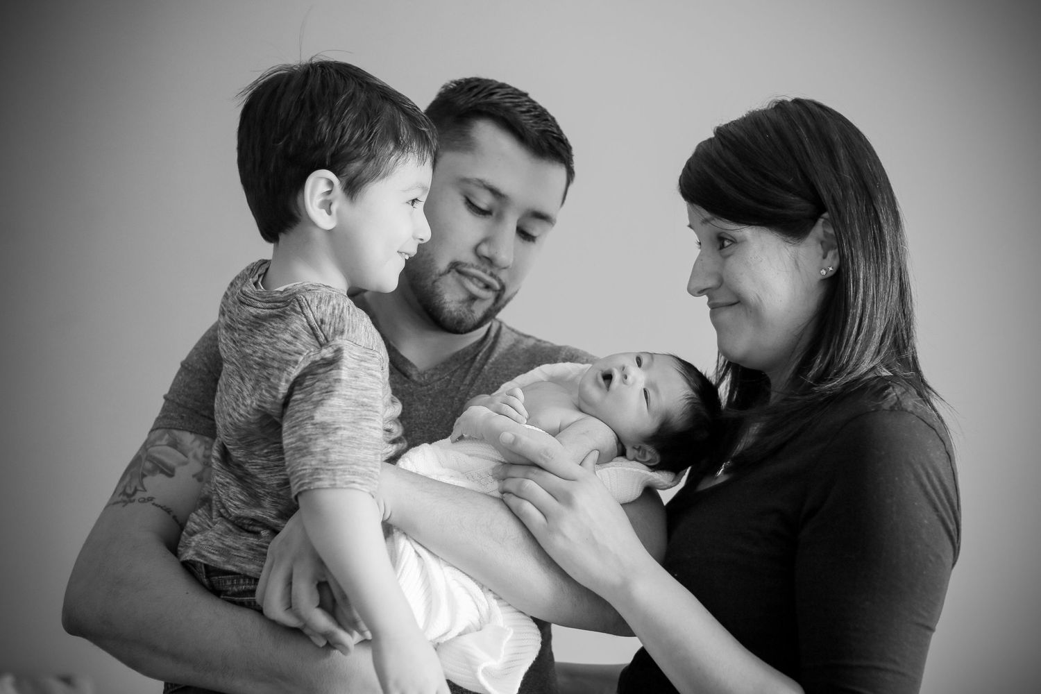 Black and white portraits capturing intimate family interactions and tender moments.