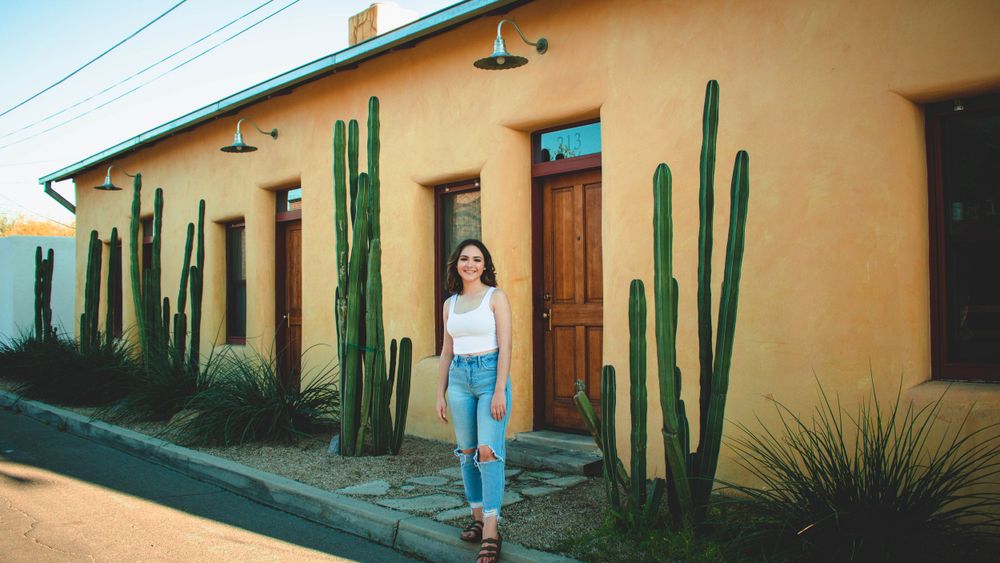 Adobe style building exterior with tall saguaro cacti and desert landscaping.
