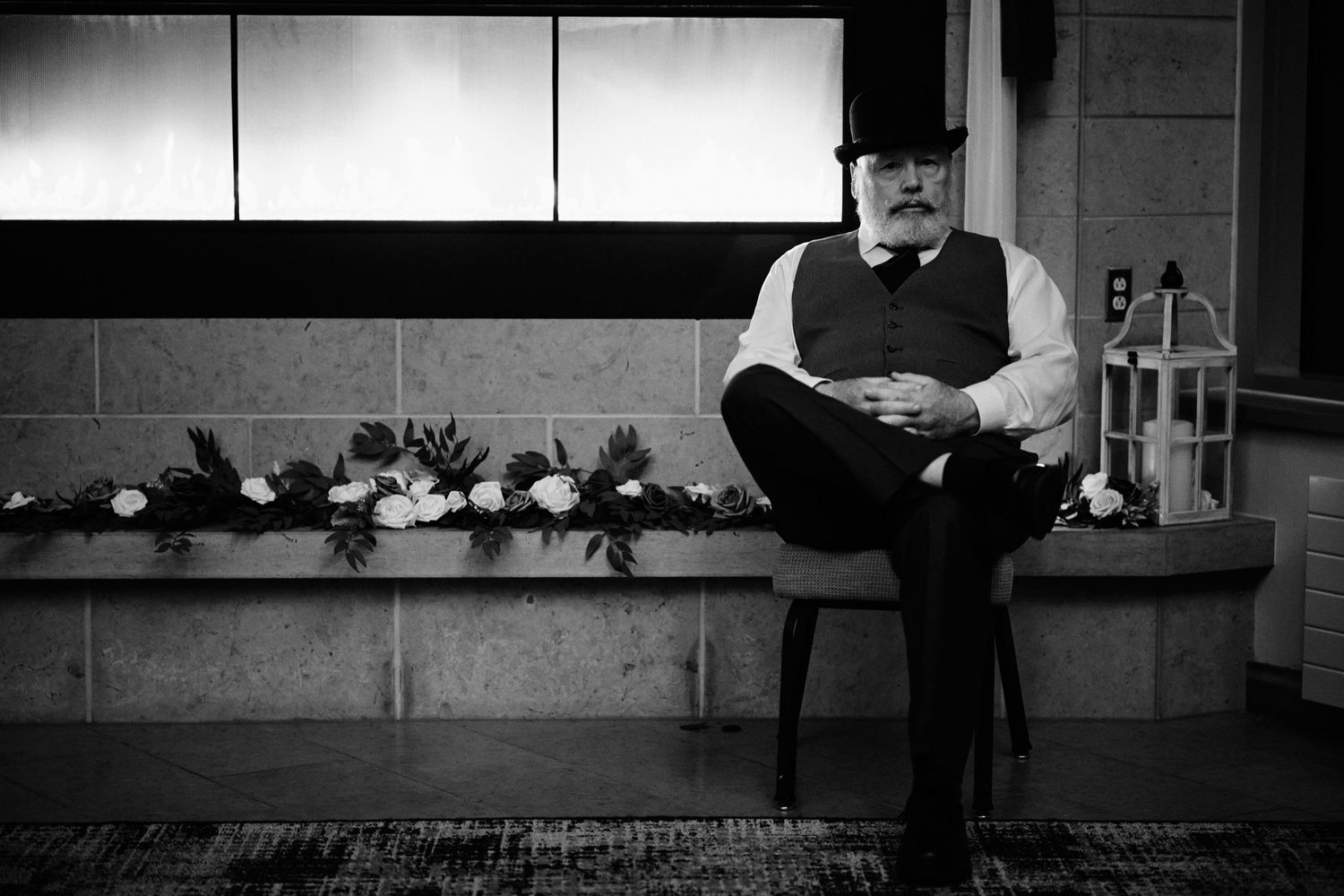 White bearded man in a top-hat sitting next to a fireplace - Green Bay, Wisconsin Wedding Photography.