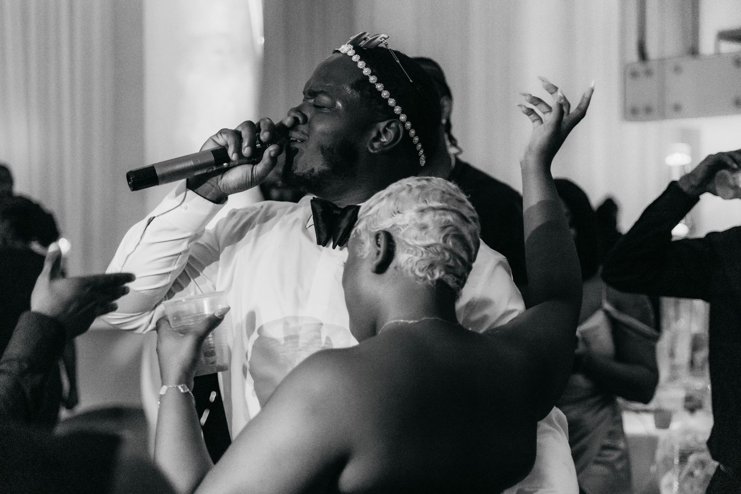 Black and white reception photos showing guests dancing and celebrating.