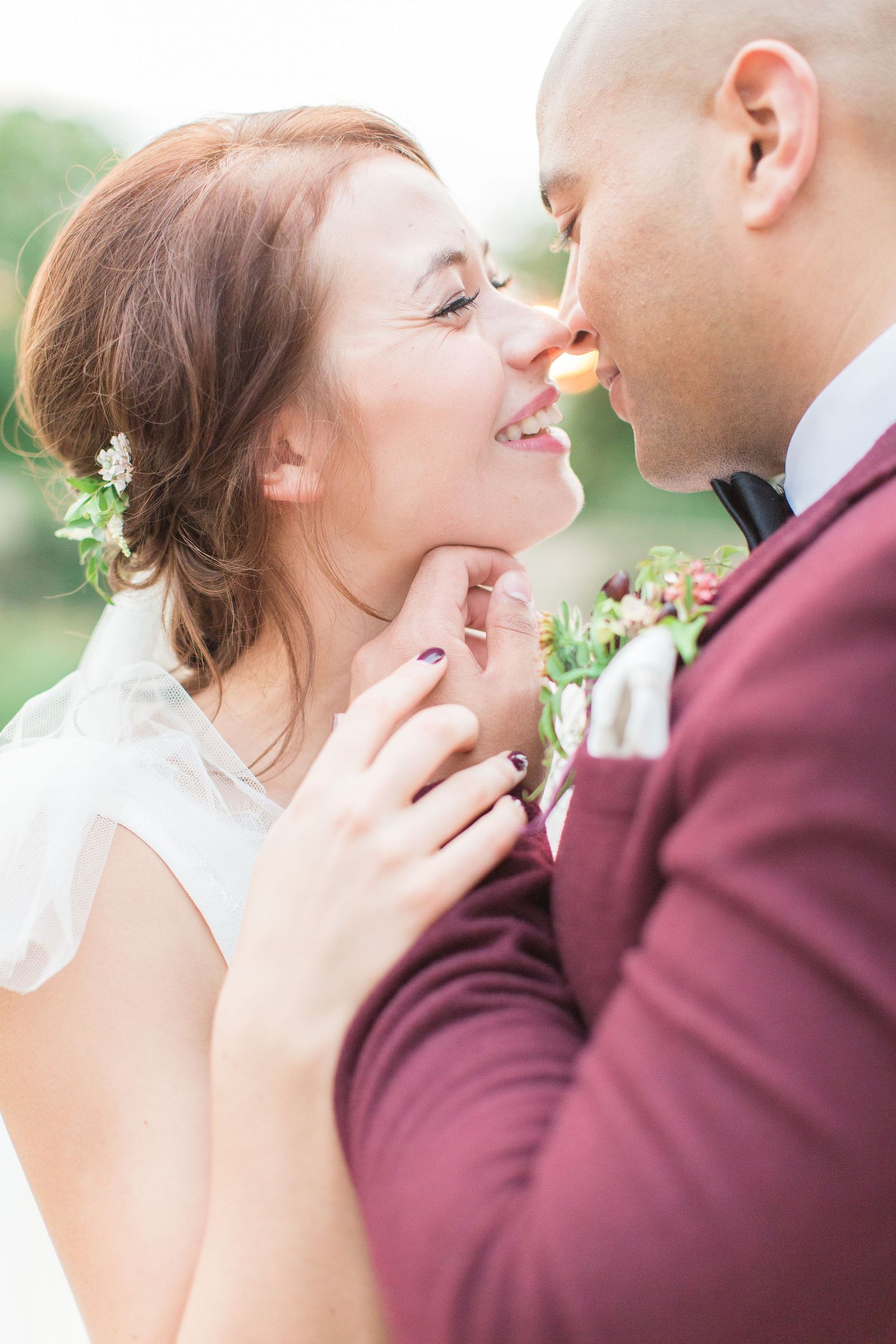 A tender romantic moment between newlyweds in wedding attire captured in soft natural lighting outdoors euridge manor